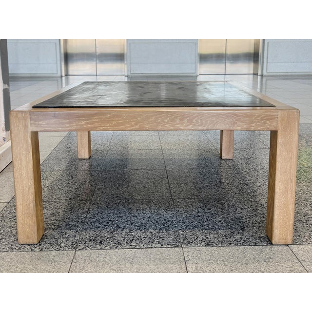 A late 20th Century square coffee table with an oak wood frame and steel plate inset top. The overall design can be...