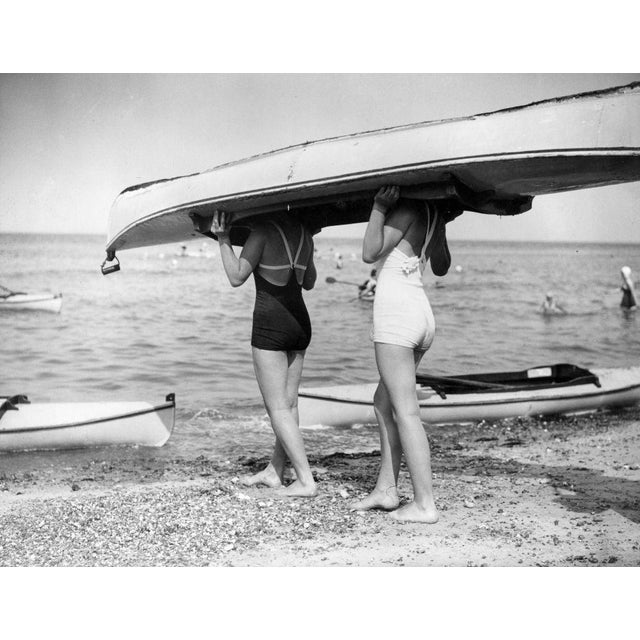 Boat Bearers 30th July 1938: Two swimsuited girls are carrying their canoe on their heads. (Photo by Gerry Cranham/Fox...