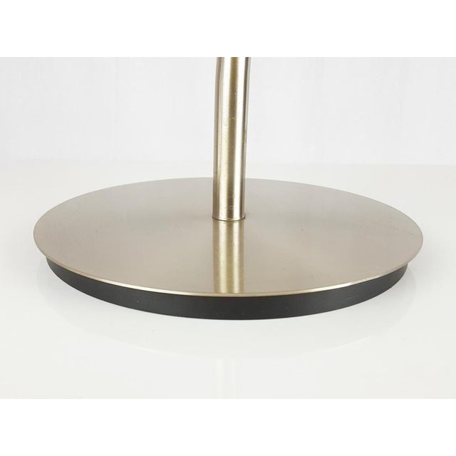 This "professional" table lamp is made from nickel metal and acrylic glass with pivotable lampshade. The lamp remains in...