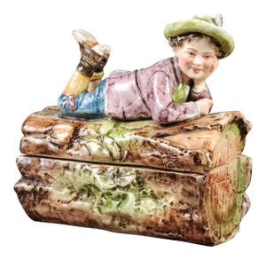 French 19th Century Barbotine Bonbon Box Depicting a Boy Laying on a Tree Trunk
