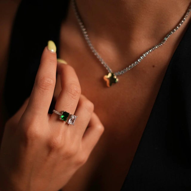 The Emerald & Diamond Design Sterling Silver Statement Ring, a stunning piece that seamlessly blends elegance with...