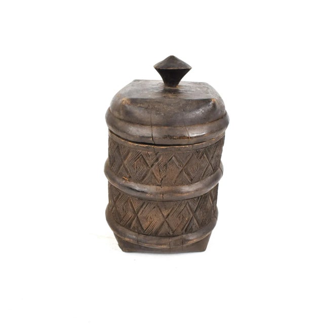 A well-carved wood Kuba container. Could be used for storing small items or just as decor. Carved containers are among the...