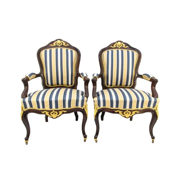 Pair of Louis XV-style armchairs / Fauteuils from the late 19th century; Made of walnut wood, with an upholstered seat,...