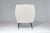 An Italian lounge chair from the 1950s, defined by its light wingback silhouette, generous proportions, and elegantly...
