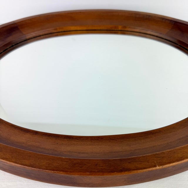 Add timeless charm to your space with this authentic Tell City Chair Company oval wall mirror, crafted in the USA from...