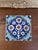 This hand-painted ceramic tile features a traditional Ottoman-inspired floral design in vivid cobalt blue, turquoise, and...