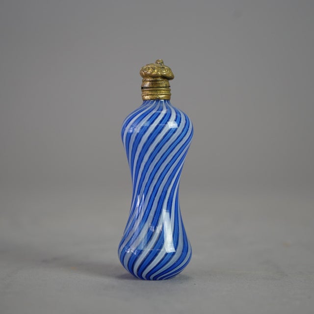 An antique Victorian Latticino perfume offers blue and white swirl art glass construction in hourglass form having a...