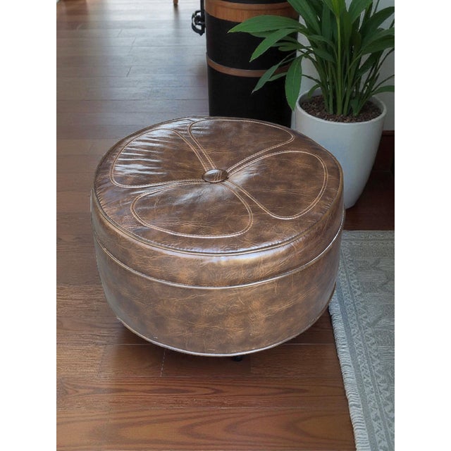 This mid-century modern brown leatherette daisy top ottoman footstool on wheels is a stylish and functional addition to...