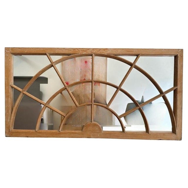 A fascinating pair of antique Georgian-style transom windows thoughtfully converted into decorative mirrors. Crafted in...