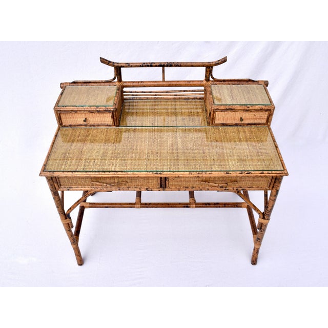 Midcentury burnt tortoise bamboo and grass cloth desk with British Colonial design elements featuring two glove boxes, two...