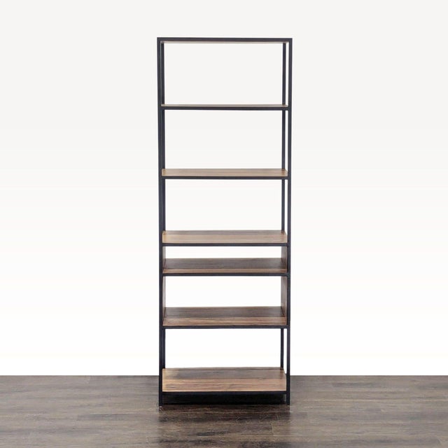 This bookshelf features a sturdy black metal frame and five spacious wooden shelves. Its open design is perfect for...