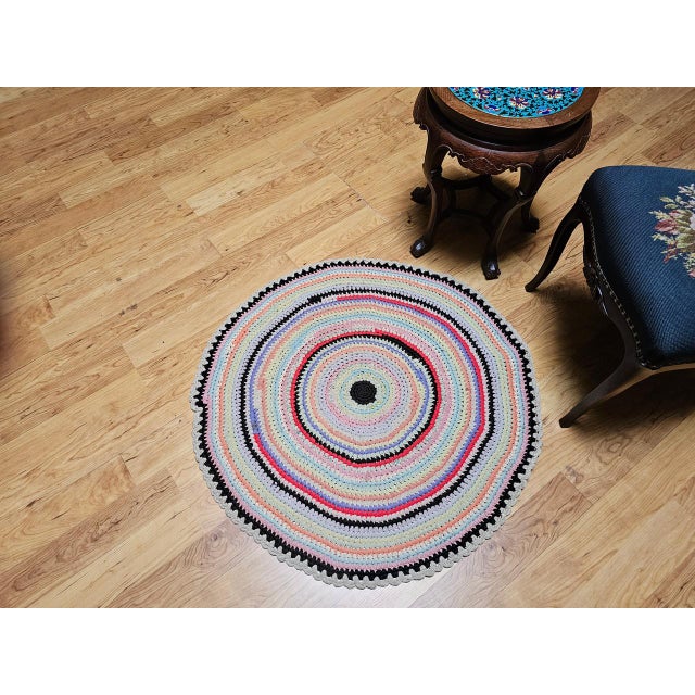 A vibrant and beautifully preserved antique American braided round rug dating to the second quarter of the 20th century,...