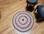 A vibrant and beautifully preserved antique American braided round rug dating to the second quarter of the 20th century,...