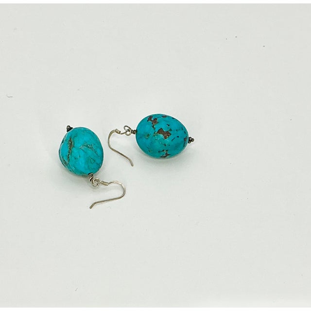 Sometimes the simple designs are the most striking. That’s the case with this pair of faux Turquoise nugget pierced Drop...