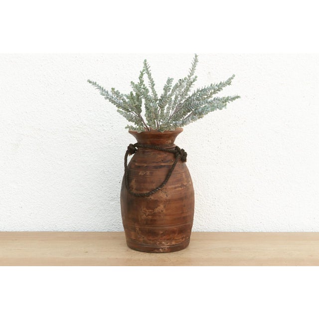 Originally used in village homes for storing milk, ghee, or grains, this antique wooden pot has survived generations of...