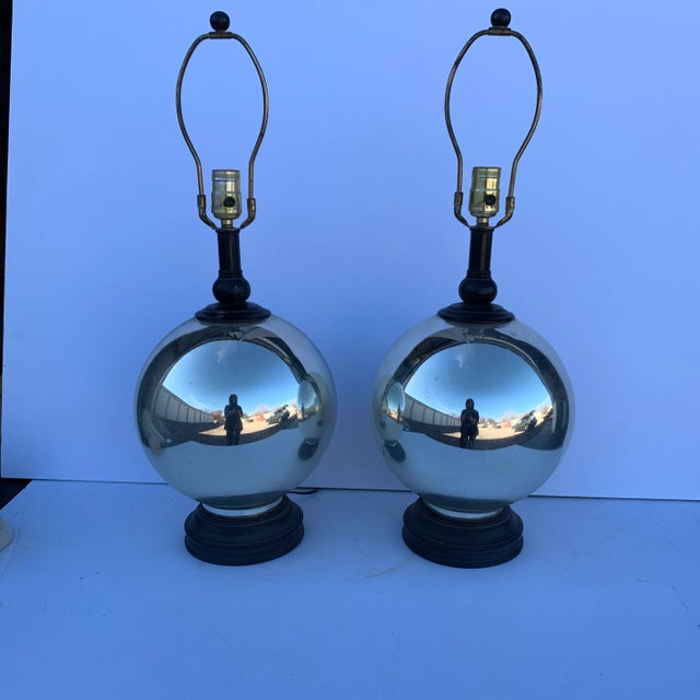 A stunning pair of C1950-60 mercuy glass/ round lamps resting on black bases. These are such great lamps that will fit...