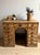 This antique French desk is a beautifully timeworn example of practical craftsmanship, featuring a solid, generously...