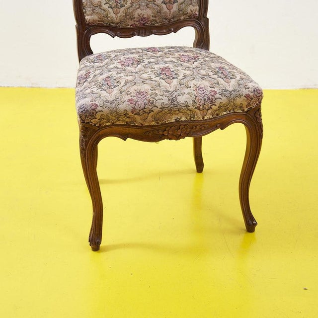 Discover the timeless elegance of this baroque-style chair, featuring delicate floral upholstery in pastel tones. Its...