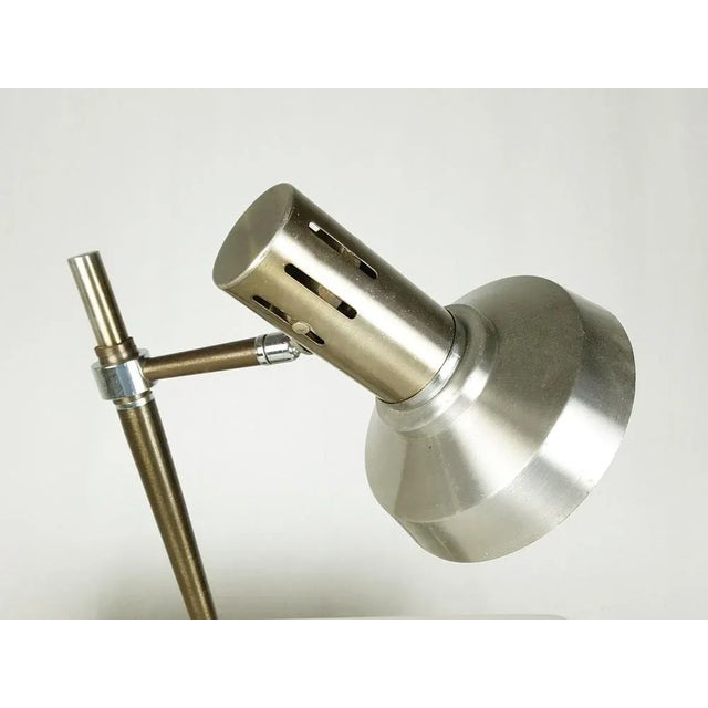 Table or desk lamp produced in Italy in the 1960s. Chrome-plated metal and anodized aluminum with bronze finish....