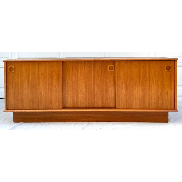 Here is a STUNNING piece that was made in Denmark by Dyrlund in the mid-century. I believe it is teak and features veneer...