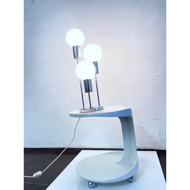 Table lamp from the 1970s, three-light, E14 socket. Chrome-plated metal base, spherical glass shades. Good used condition....