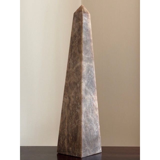 Offering a beautiful 17.5" Neoclassical-style sculptural onyx obelisk from the mid- to late-20th century. Love the natural...