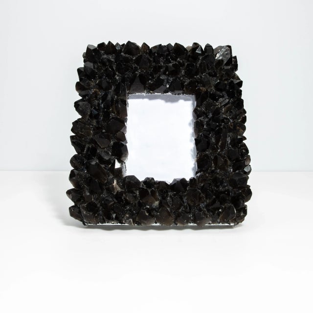 This Kathryn McCoy frame, adorned with black quartz crystals, is a perfect blend of elegance and natural beauty. The frame...