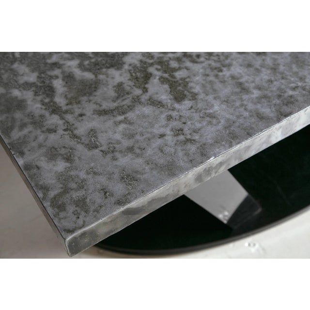 Industrial, modern tin topped coffee table. Oval black Formica wooden base with quadrilateral shaped legs to support a...