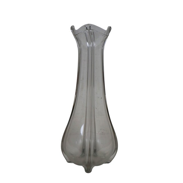 Large vintage clear glass hand blown vase. Features a bulbous base and flared ruffled top, with raised ridges fron the...
