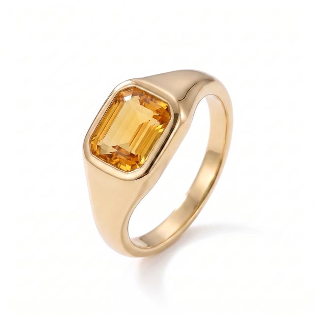 A modern interpretation of the classic signet ring, this elegant design showcases a golden citrine in a sleek bezel...