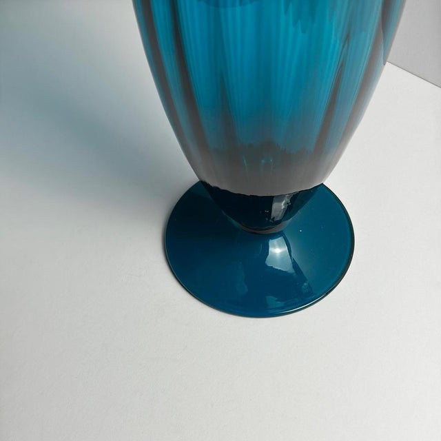 A tall peacock blue art glass vase, handblown in Empoli, Italy, circa 1960s, and attributed to Rossini—a name associated...