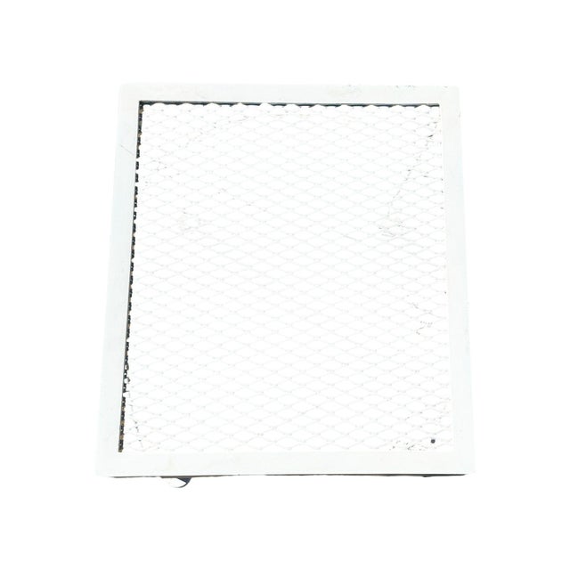 Mid-century wrought iron and steel mesh low coffee table for patio and outdoor use by Woodard. The coffee table features a...