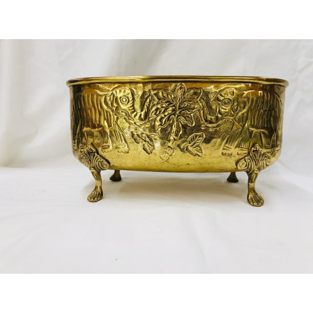 Footed brass decorative bowl with elephants and palm tree design. Marked India.