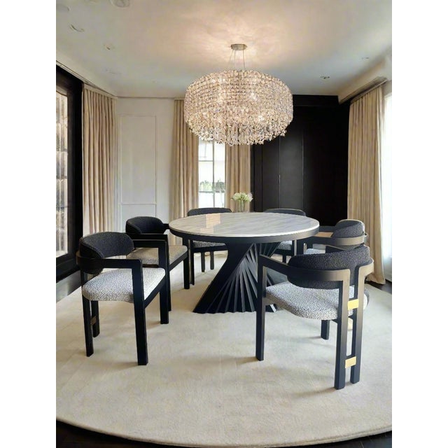 Sophisticated materials draw inspiration from modern geometry to create this stunning dining room set for six people. The...