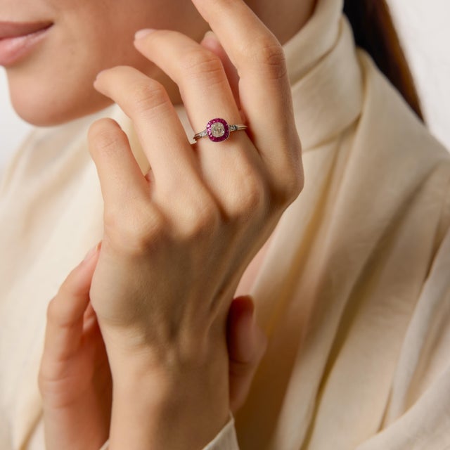 A striking homage to the glamour of the 1930s, this Art Deco–inspired target ring centers on a captivating 0.53 carat old...