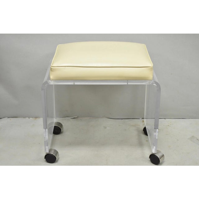 Vintage Mid Century Modern Clear Lucite Acrylic Waterfall Vanity Bench Stool on Wheels with Faux Ostrich Print Upholstery....