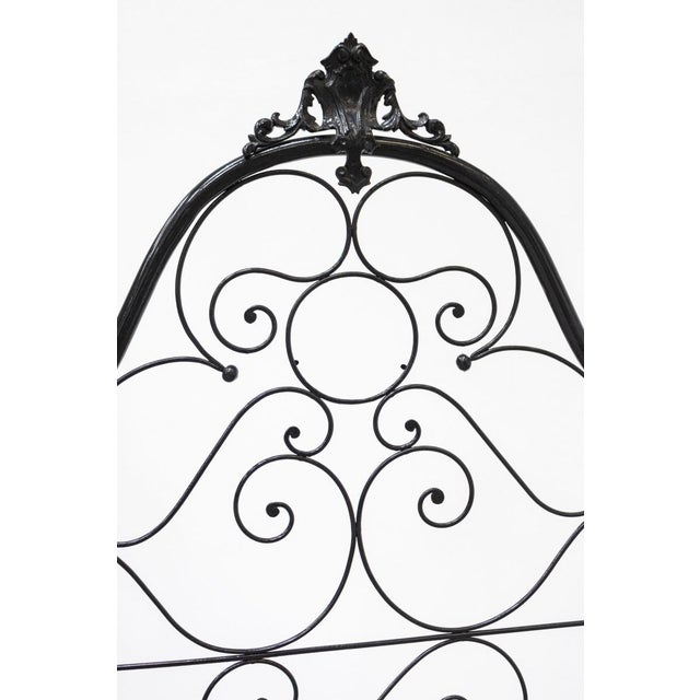 French wrought iron bed, mid-19th century The structure is tubular, richly decorated and with a circular element with a...