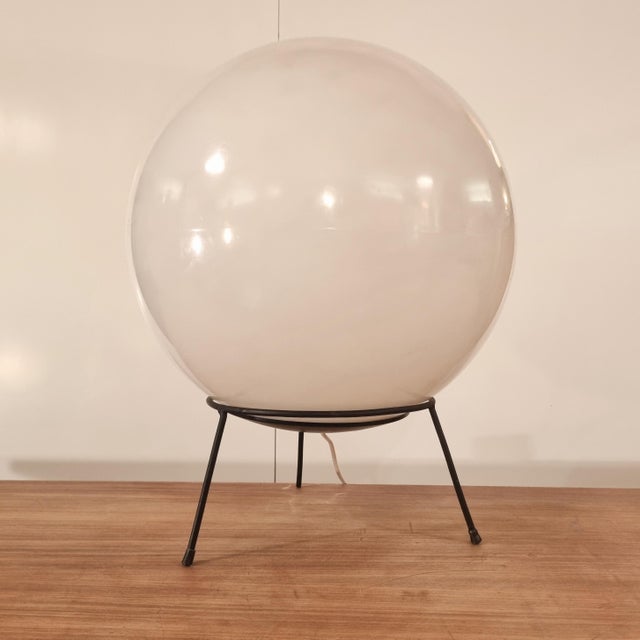 A large plastic sphere or ball on a black metal frame. The sphere resembles the mooi. A beautiful piece of lighting, made...