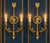 A pair of bronze two-light neoclassical wall sconces. available an other pair with red decoration. Measurements: cm 48 x...