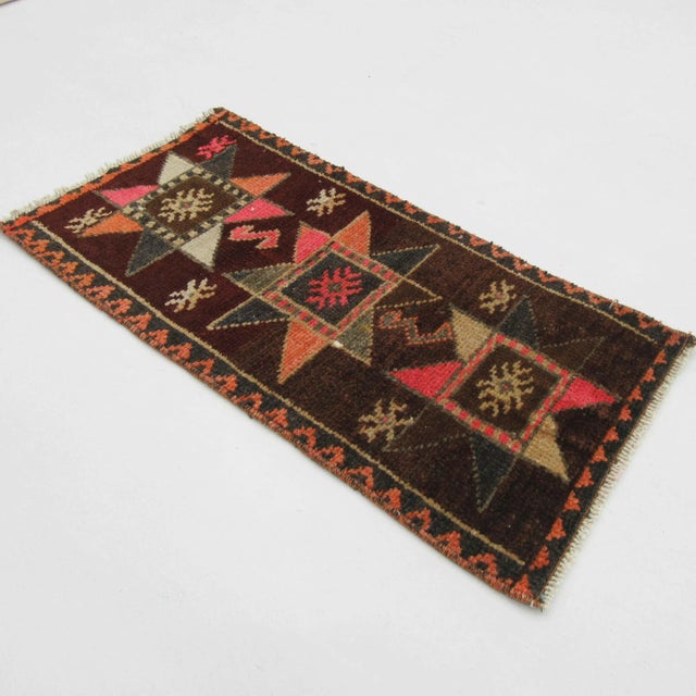 Handknotted vintage decorative mini rug from Kars region of Turkey. Approximately 50-60 years old. In very good condition.