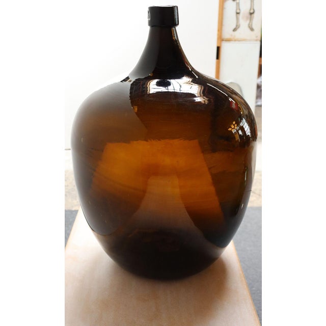 French Demijohn / Carboy originally used for transporting wine (early 20th Century, France). Composed of attractive amber...