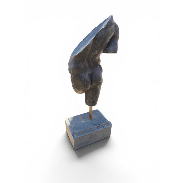Elegant stone sculpture depicting a classical Greek torso, inspired by the fragmented masterpieces of Ancient Greek and...