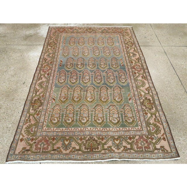 This mid-20th-century Persian Malayer accent rug presents a finely ordered allover composition across a soft blue field....