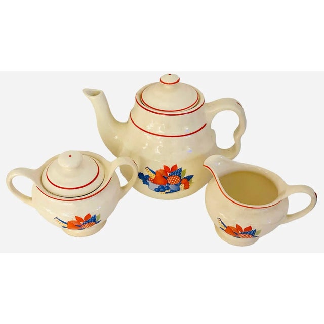 Calico Fruit by Universal Tea Pot with Lid (4 cups) and one Sugar and Creamer set.