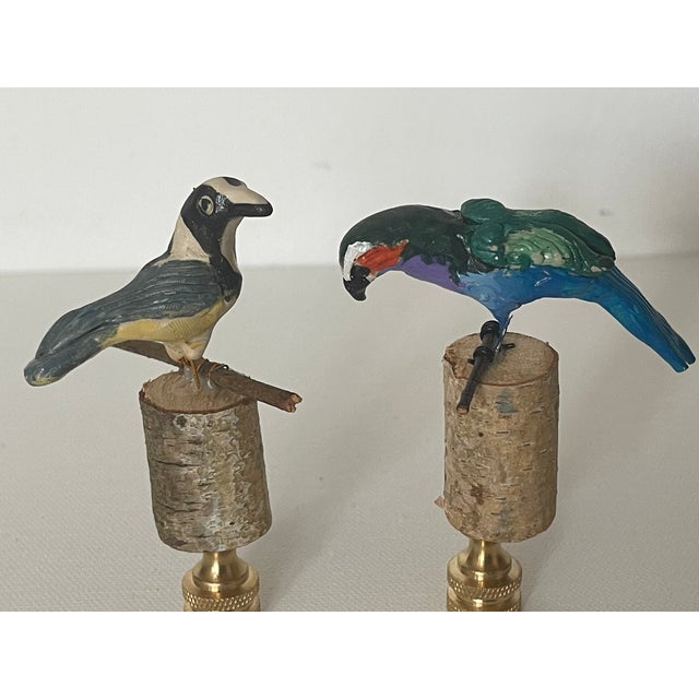 Cute pair of artisan made and signed bird figurines mounted on brass bases as lamp finials.