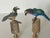 Cute pair of artisan made and signed bird figurines mounted on brass bases as lamp finials.