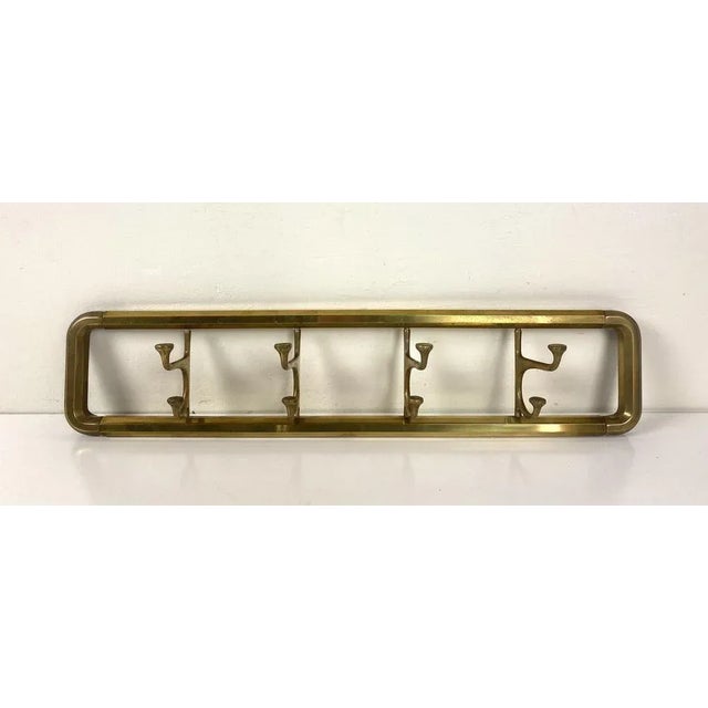 Beautifully designed Art Deco style coat rack with folding hooks. Nice quality brass with light patina, with a hexagonal...