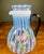 Signed Fenton 75th Anniversary guest set art glass pitcher. Light blue opalescent in color featuring a plum handle.