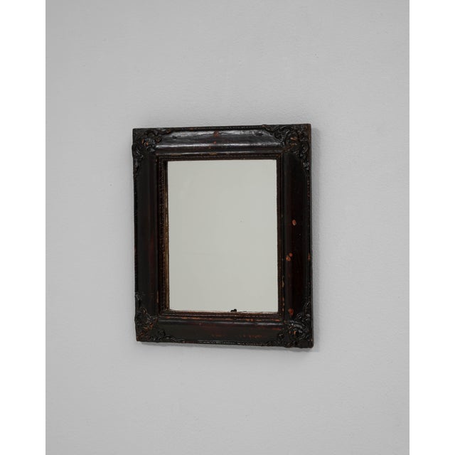 This 19th Century French wood black patinated wall mirror exudes timeless charm and understated elegance. Framed in richly...