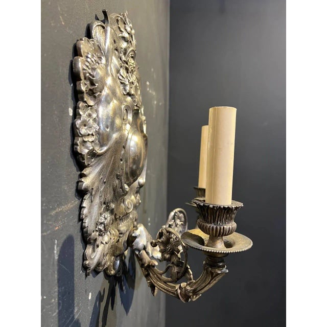 A circa 1900's English baroco style silver plated sconces with a two woman and flowers. Unique and unusual design with a...